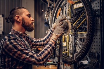 person servicing bikes